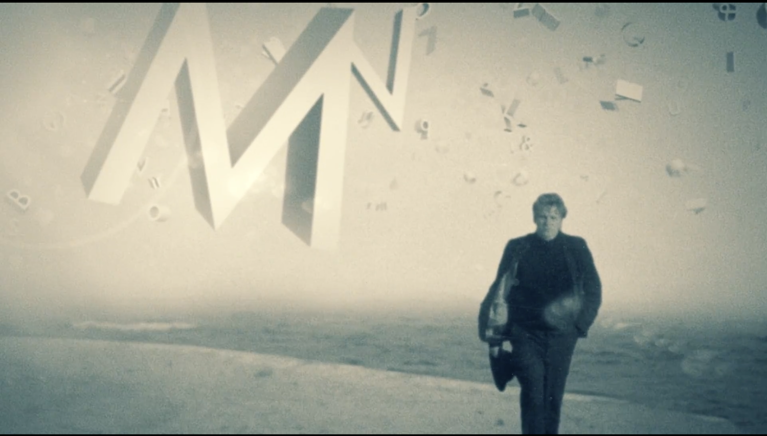 screen capture from "The Complete Works" by Justin Stephenson depicting bpNichol walking on a beach with three dimensional letter floating in the sky around him.